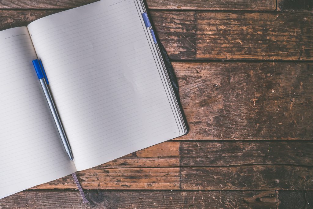 photo of a notepad lying open on a desk