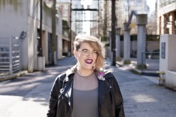 An image of Hannah McGregor in downtown Vancouver. She is beaming.