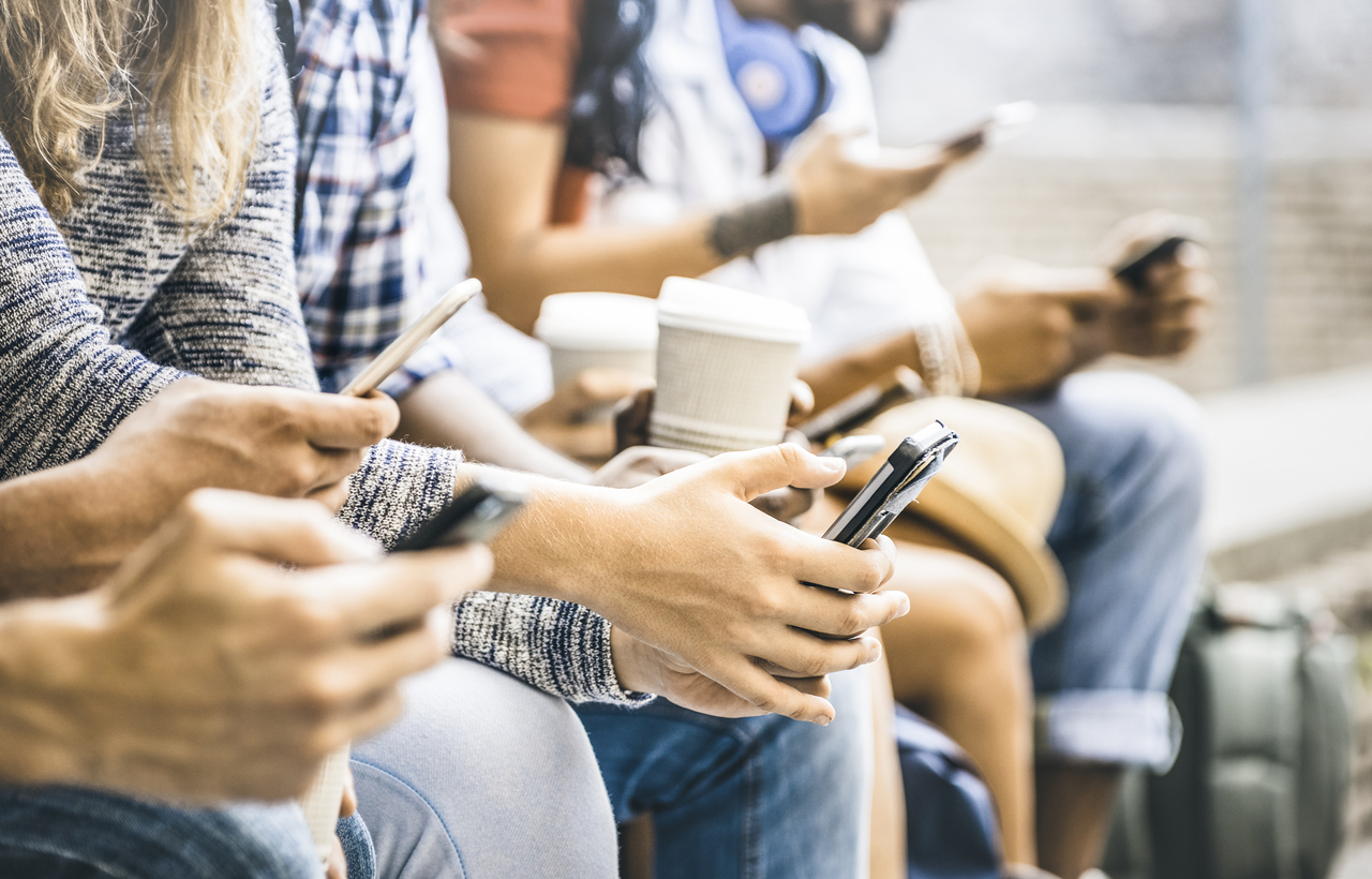 Friends group using smartphone with coffee at university college break 