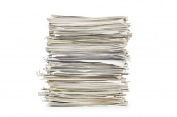 Large stack of papers on a white background