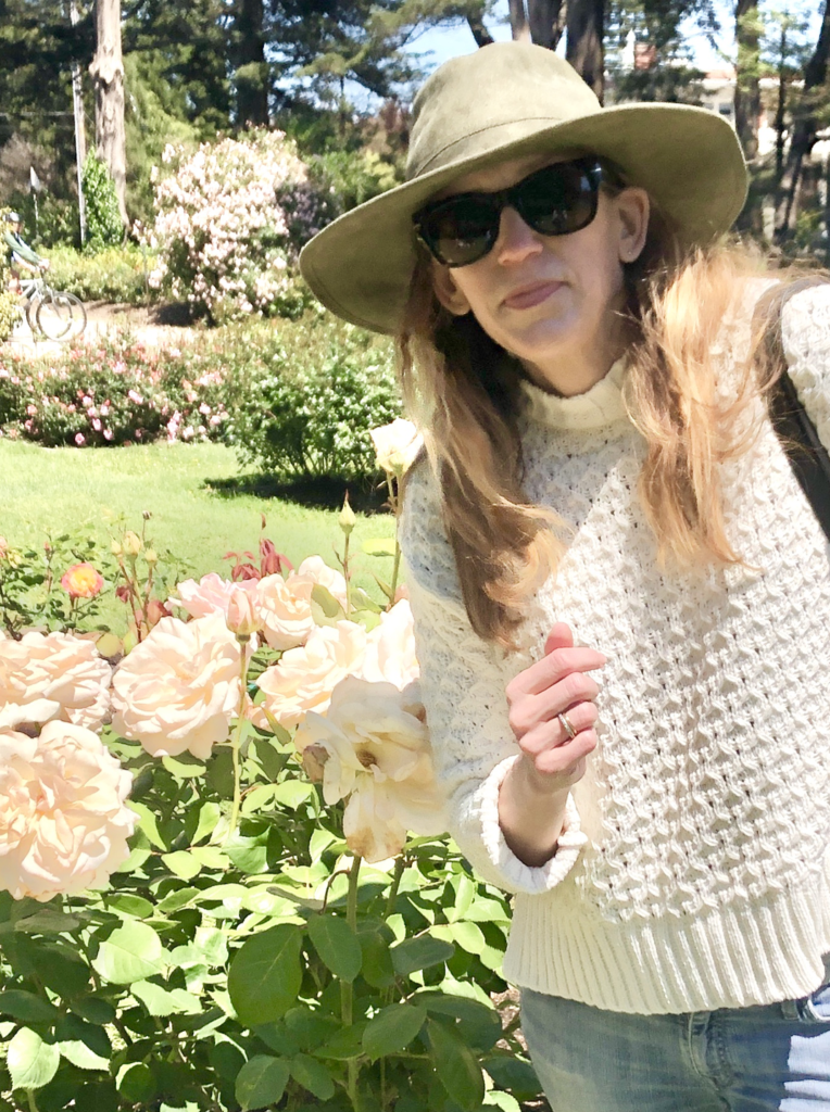 Laura Moorhead, in a hat and sunglasses, enjoys the sun at Golden Gate Park 