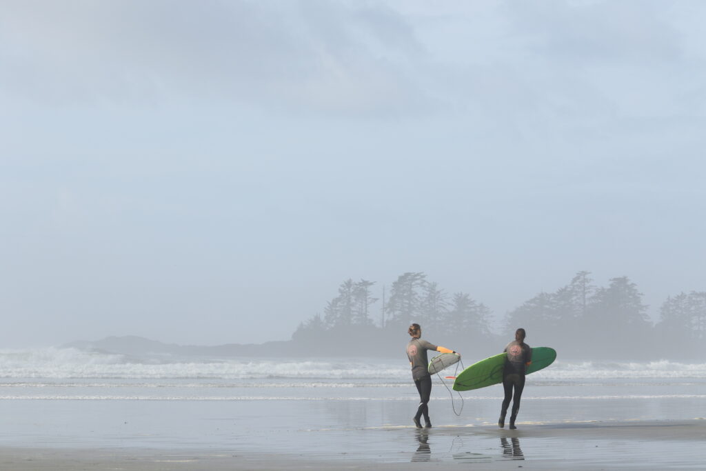 Olivia Aguiar on her way to catch some waves amid the morning haze in Tofino, B.C.
